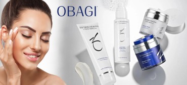 Obagi ZO Skin Health banner with a smiling woman touching her face and skincare products including hydrating crème, hydro mist, and recovery crème